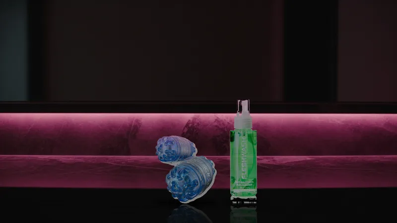 Quickshot Turbo and Fleshwash bottle on a dark marble shelf lit by pink neon