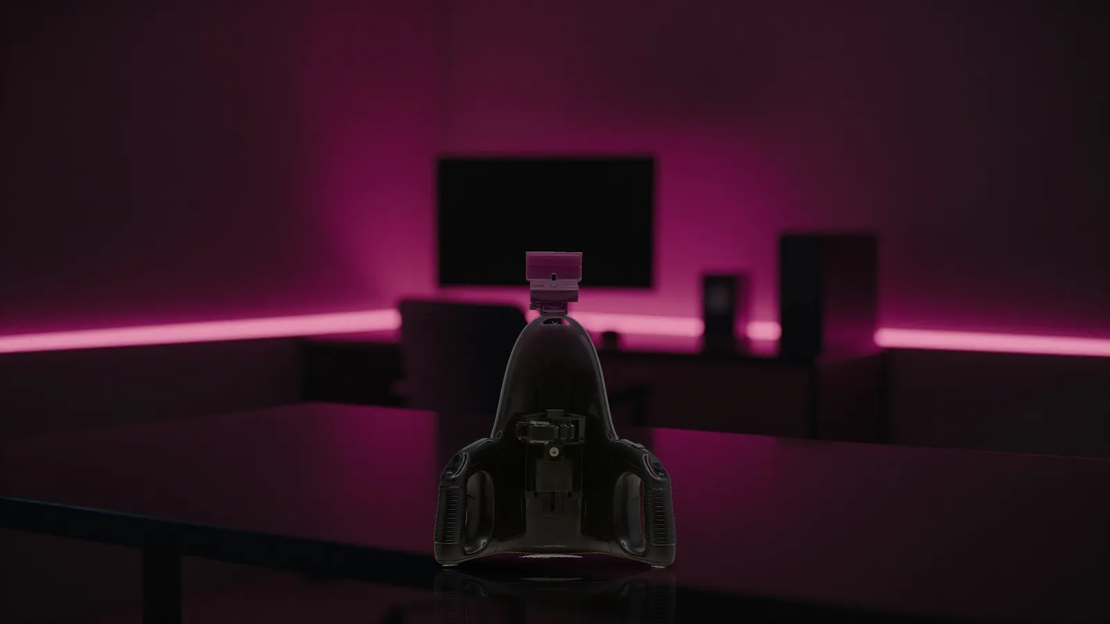 Universal Launch device on a dark cyber-noir desk lit by magenta neon
