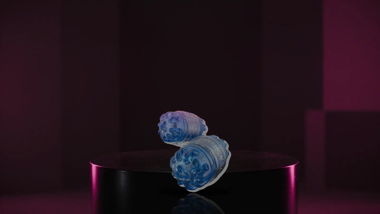 Quickshot Turbo on a glossy black pedestal with magenta rim light