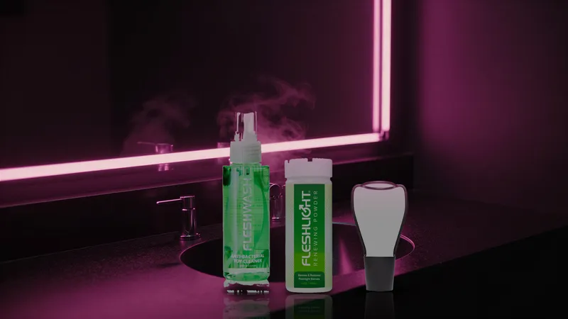 Fleshwash cleaner, Renewing Powder, and a Stand Dry rack on a dark bathroom counter lit by pink neon