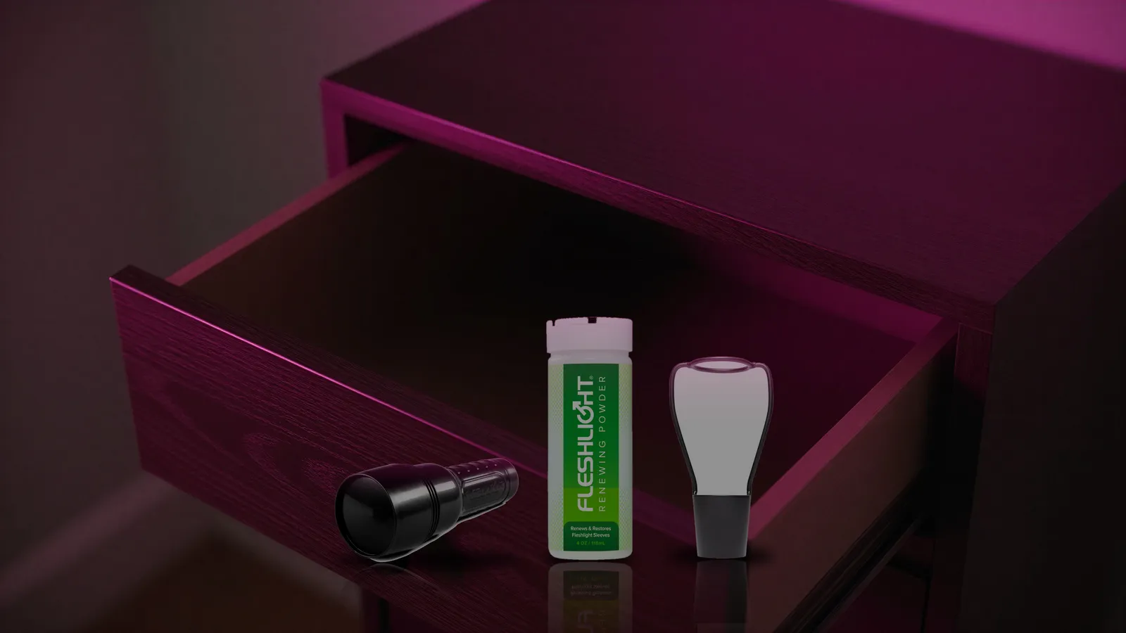 Closed Fleshlight case, Renewing Powder, and Stand Dry stored in an open nightstand drawer