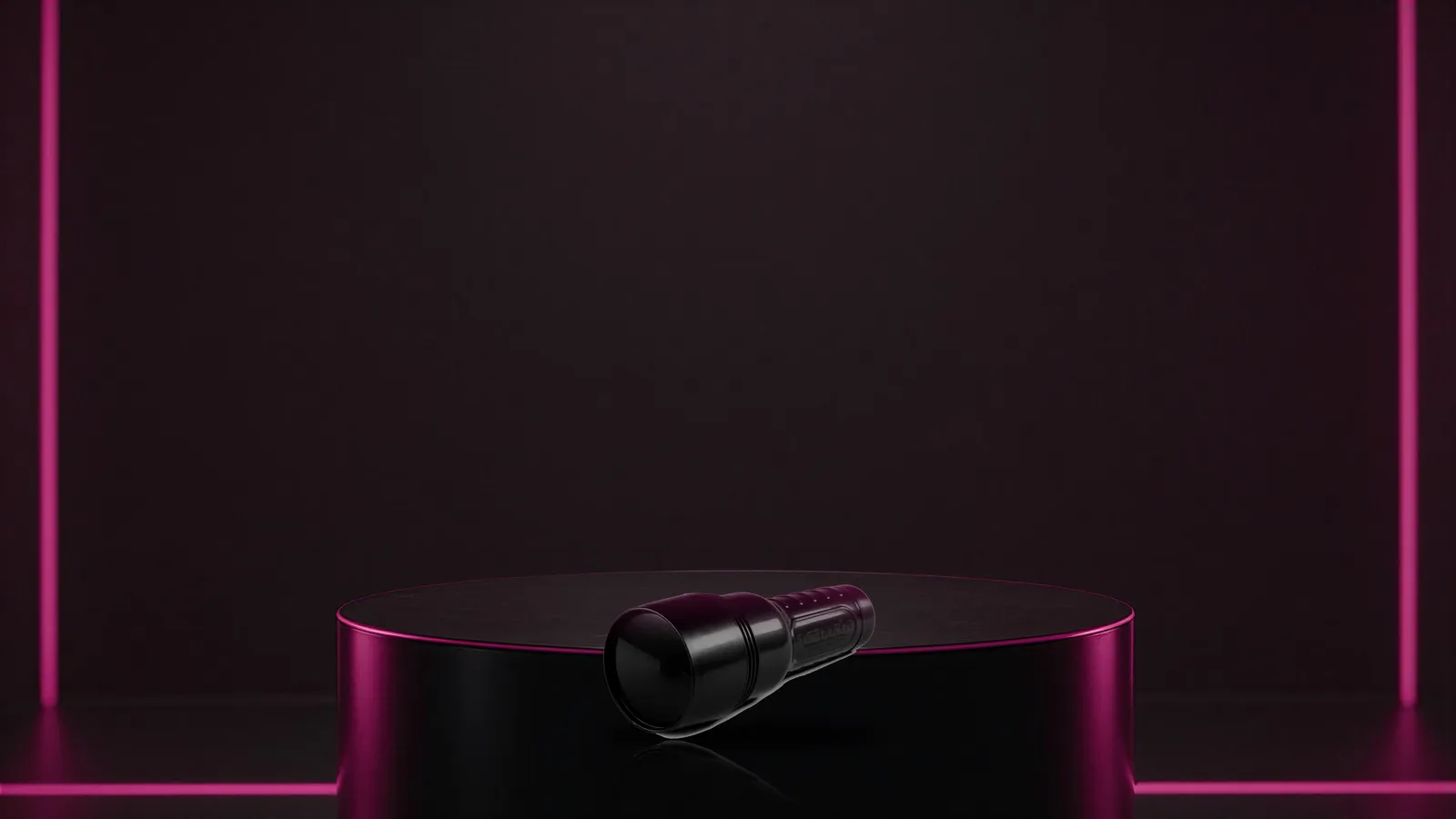 Closed black Fleshlight case on a minimal glossy pedestal under a tight spotlight
